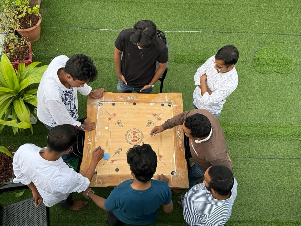 Friends Enjoying a Game of Carrom
