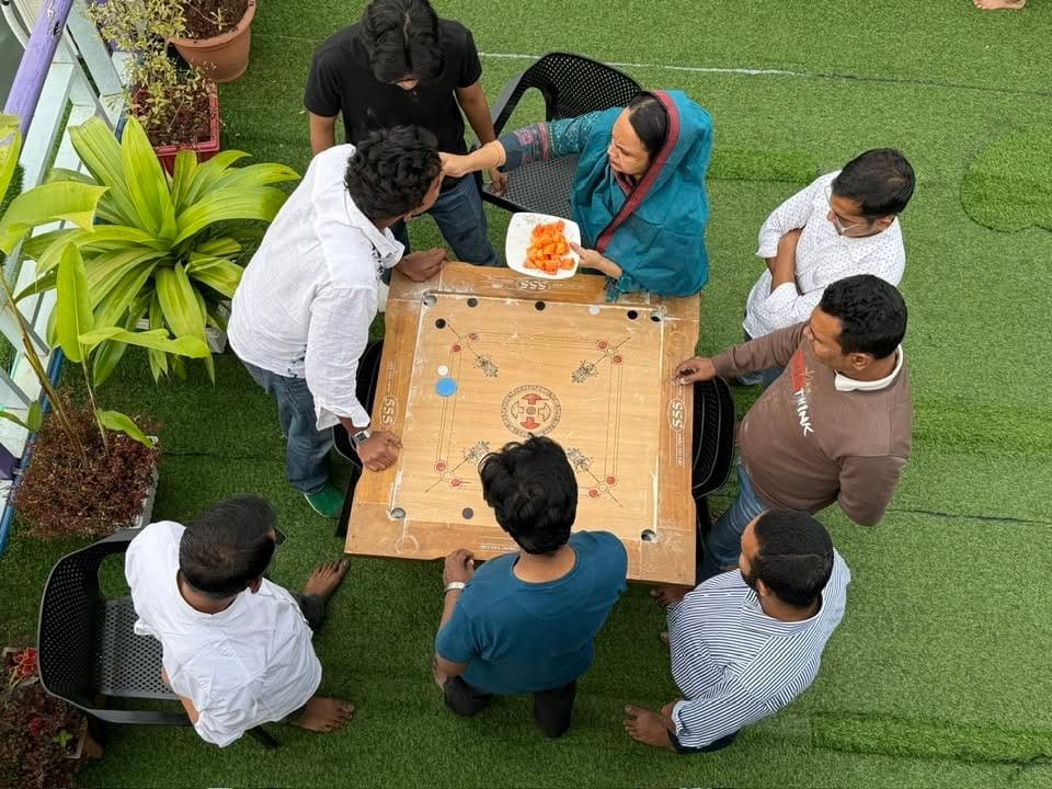 Friends Gathering Around a Carrom Board