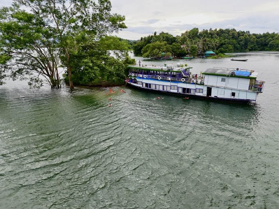 Swimming by the Royal Boat near a Serene Island